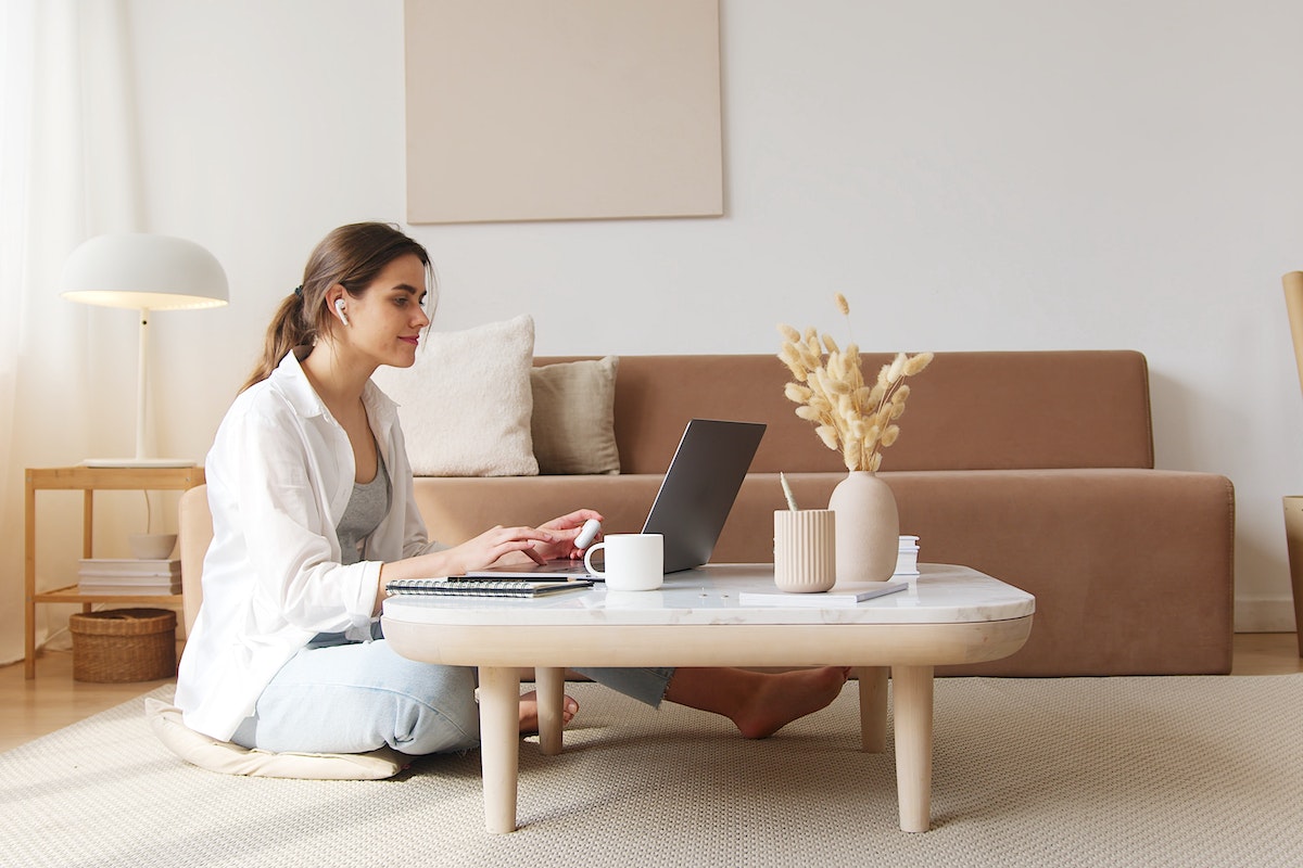 Content-woman-using-laptop-on-floor